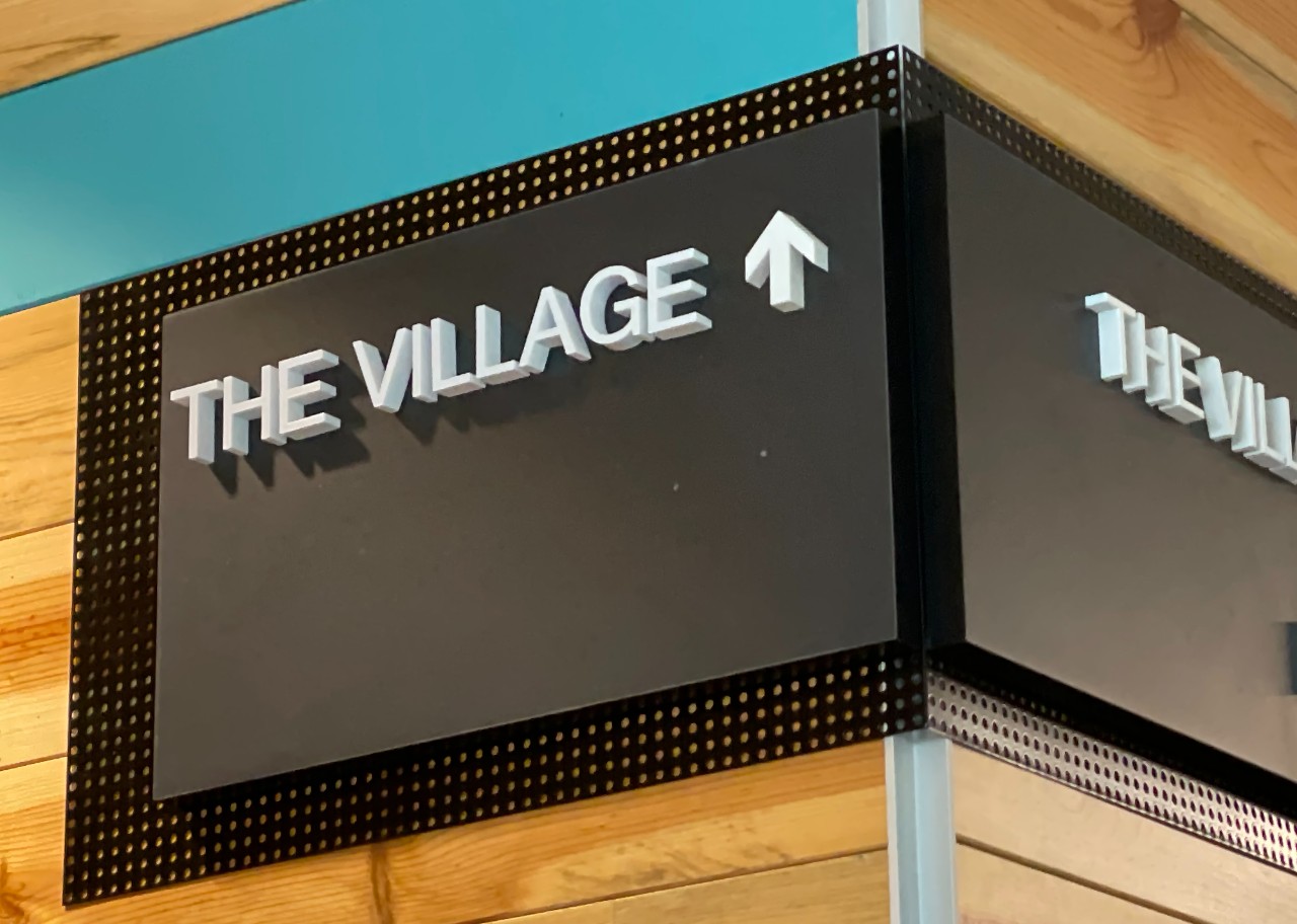 A wall sign with the words "The Village".